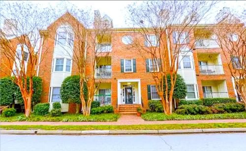 a large brick house with trees in front of it at Amazing Beautiful Downtown Apt in Norfolk