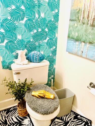 a bathroom with a toilet with a blue and white wallpaper at Amazing Beautiful Downtown Apt in Norfolk