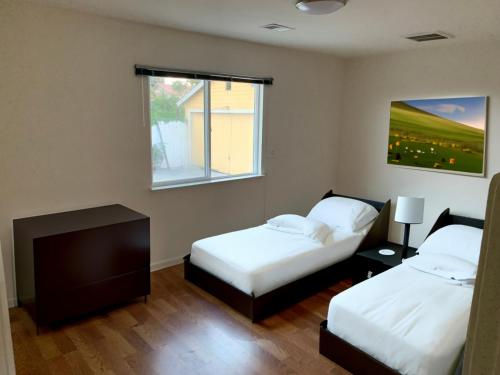 サンノゼにあるWest Wingのベッド2台と窓が備わる客室です。