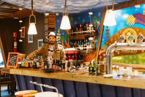 a bartender behind the bar of a restaurant at Mamallacta Páramo Lodge in Papallacta