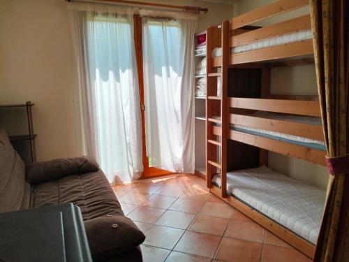 a living room with two bunk beds and a couch at Appartement Corrençon-en-Vercors, 3 pièces, 7 personnes - FR-1-761-7 in Corrençon-en-Vercors