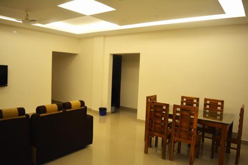 a dining room with a table and chairs at NEW MOUNT RESIDENCY in Sultan Bathery