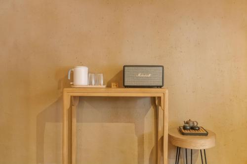a table with a radio on top of it at Xianqingshan Homestay in Hangzhou