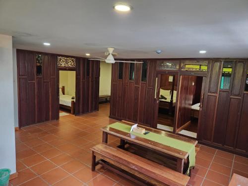 a room with a bench and wood paneled walls at Uptown Eco Hotel in Kuala Terengganu