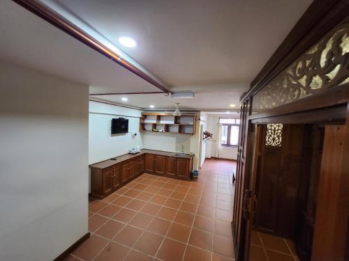 an empty room with a kitchen in a house at Uptown Eco Hotel in Kuala Terengganu