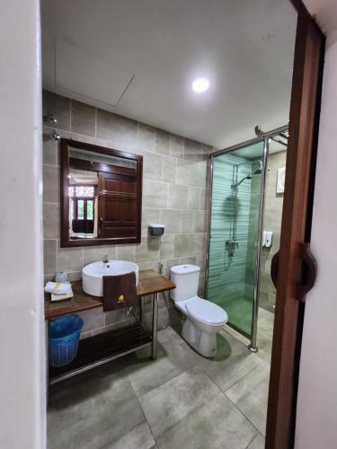 a bathroom with a toilet and a sink and a shower at Uptown Eco Hotel in Kuala Terengganu