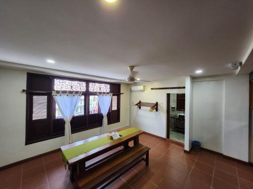 a living room with a bench and a window at Uptown Eco Hotel in Kuala Terengganu