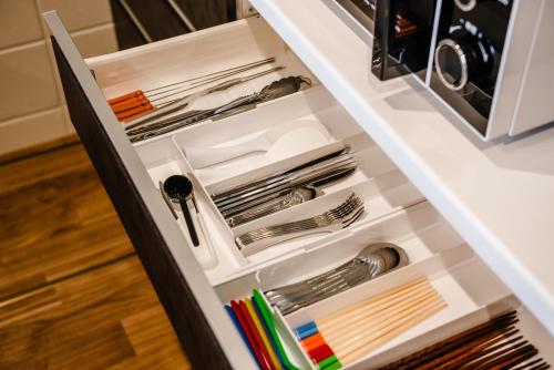 a drawer in a kitchen filled with utensils at LEGO in Uruma