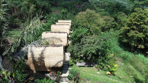 an overhead view of a group of straw homes at Sten Lodge in Labuan Bajo