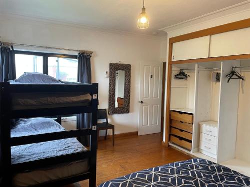 a bedroom with two bunk beds and a mirror at Bairnsdale Workers Accommodation in Lucknow