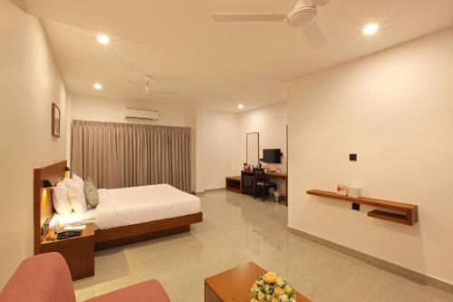 a bedroom with a bed and a living room at HOTEL PRINCE in Kāladi