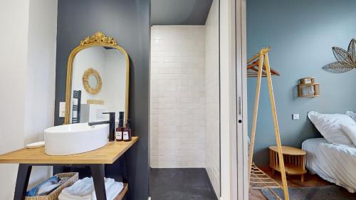 a bathroom with a sink and a mirror at Le porte plume in Dole