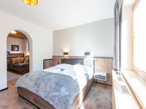 a bedroom with a large bed with a wooden headboard at Apartment Mayrhofen near Horbergbahn in Hippach