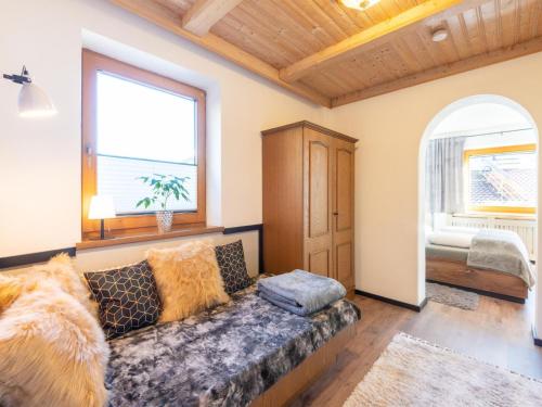 a living room with a couch and a window at Apartment Mayrhofen near Horbergbahn in Hippach