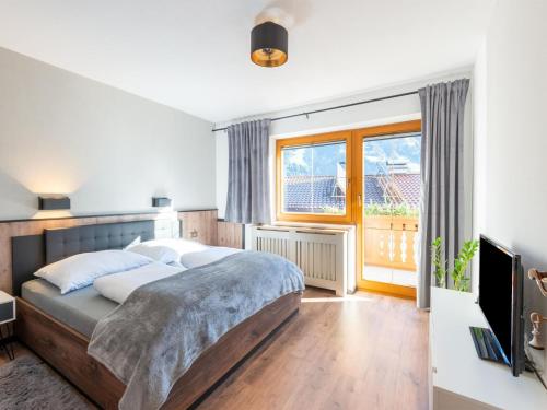 a bedroom with a bed and a window at Apartment Mayrhofen near Horbergbahn in Hippach