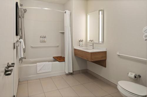 a white bathroom with a sink and a toilet at Staybridge Suites Minneapolis-Maple Grove by IHG in Maple Grove