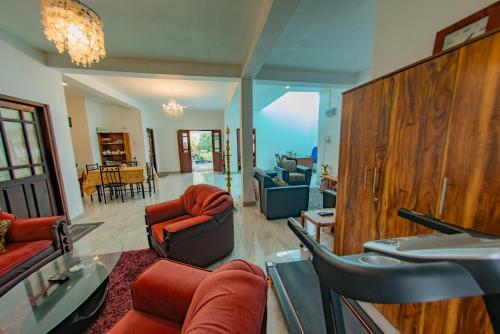 a living room with couches and chairs at Ciel Grand Villa in Kandy