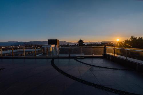 a view of the sunset from a balcony of a building at Hong Long Jing Hotel in Dali
