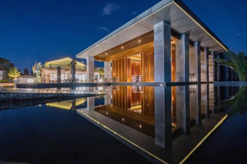 a house with a pool in front of it at Hong Long Jing Hotel in Dali