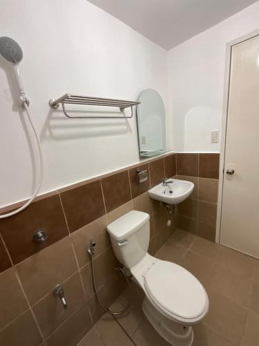 a bathroom with a toilet and a sink at Condo Rentals in Arezzo - 1 Br Condo in Davao City