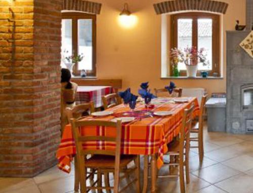 a dining room with a table and chairs in a kitchen at Antica Cascina B&B in Borghetto Lodigiano