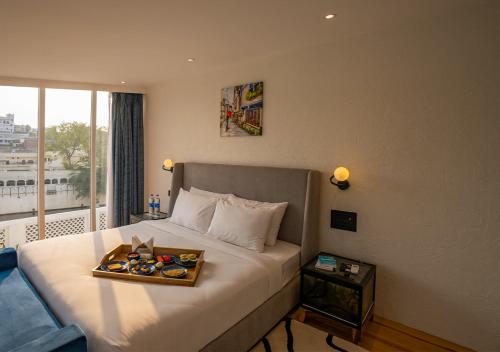 a hotel room with a bed with a tray on it at Moustache Udaipur Verandah in Udaipur
