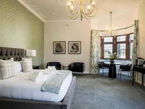 a bedroom with a large bed and a desk at Palm House Boutique Hotel in Cape Town