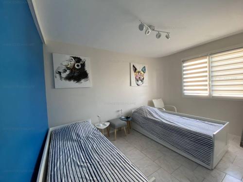 une chambre avec deux lits et une fenêtre dans l'établissement T3 Climatisé, Calme, Proche Plages et Commerces, Terrasse et Parking - FR-1-100-322, à Cavalaire-sur-Mer