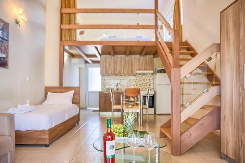 a loft apartment with a bed and a staircase at Alia Apartments and Suites in Haraki