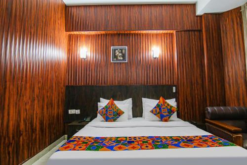 a bedroom with a bed with wood paneled walls at FabHotel Prime The Rivlet MG Road in Gurgaon