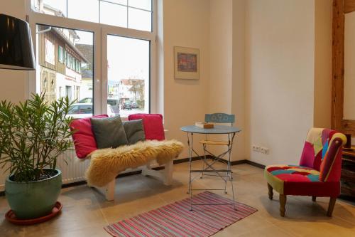 a living room with a couch and a table at Goldener Löwe in Bodman-Ludwigshafen
