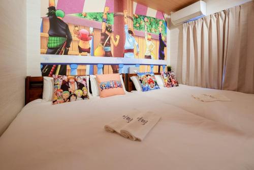 a bedroom with a white bed with a disney mural at 板橋駅前店・ダイヤモンド・悠 in Tokyo