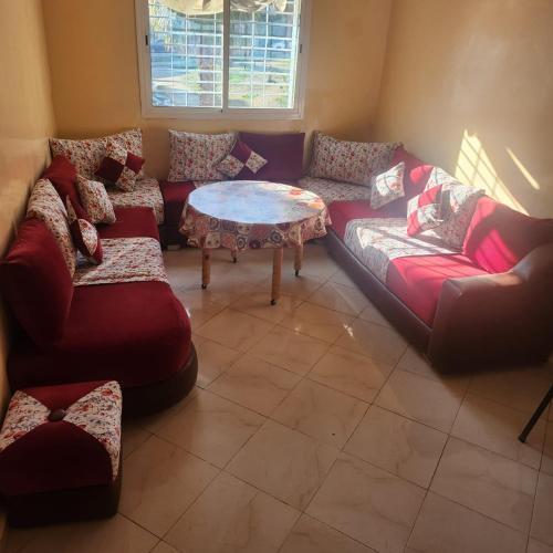 a living room with couches and a coffee table at ESC Apartments in Fès