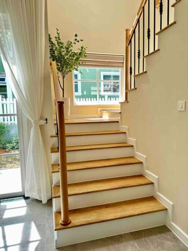 a staircase in a house with a potted plant at Novaworld Phan thiết - Alina house- 2 bed rooms in Bình Sum