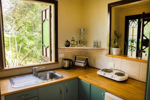 a kitchen with a sink and a window at Ashwood Cottages in Bright