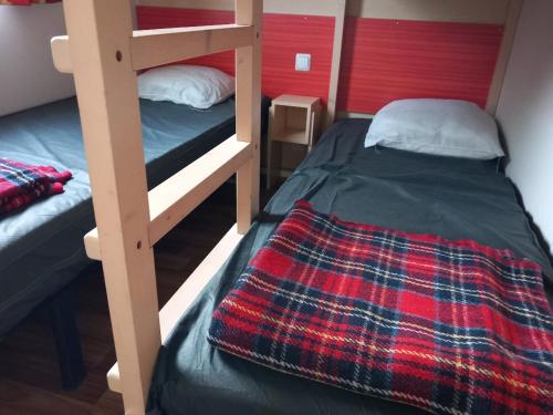 a bedroom with two bunk beds in a room at 431 Emplacement confort aux Fontaines 3 étoiles - 5 personnes in Ivry-la-Bataille