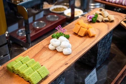 a wooden table with different types of food on it at Holiday Inn Express Beijing Downtown by IHG in Beijing
