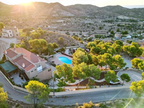 an aerial view of a house with a pool and trees at Finca El Otero in Aigues