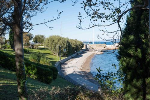 a path next to a body of water at Marylin & Elvis in Muggia