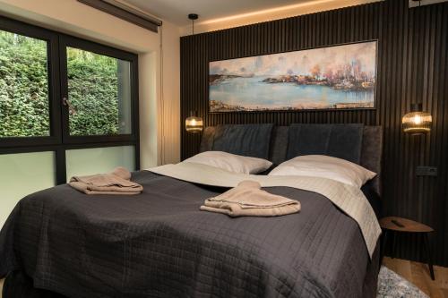 a bedroom with a bed with two towels on it at Wellness House Energy mit Whirlpool in Timmendorfer Strand