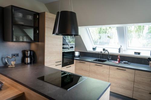 a kitchen with a black counter top and a sink at Wellness House Relax mit Whirlpool in Timmendorfer Strand