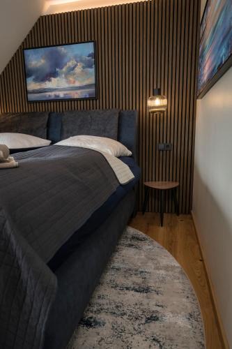 a bedroom with a bed and a tv on the wall at Wellness House Relax mit Whirlpool in Timmendorfer Strand