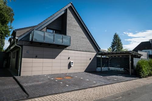 a building with a balcony on top of it at Wellness House Relax mit Whirlpool in Timmendorfer Strand