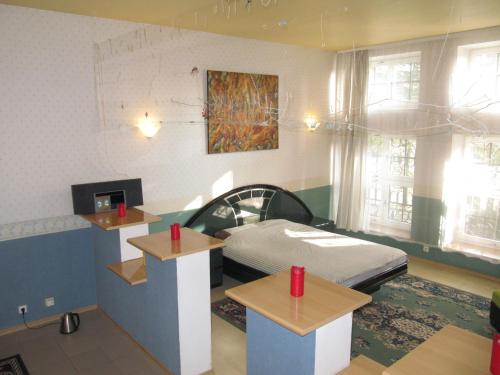 a hospital room with a bed and two tables at Apartamentai Lampėdžiuose in Kaunas