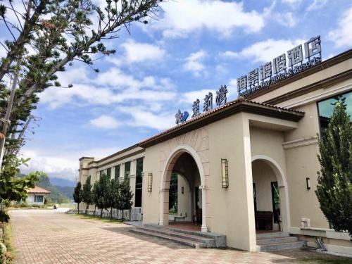 a building with a balcony on top of it at Kenting Moli Bay Seaview Resort Hotel in Fangshan