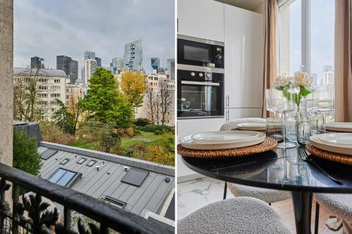 une salle à manger avec une table et une vue sur la ville dans l'établissement Apartment La Défense by Studio prestige, à Puteaux