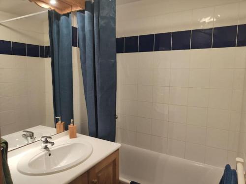 une salle de bain avec un lavabo et une baignoire dans l'établissement appart duplex récent proche des pistes et pioupiou, à Orcières