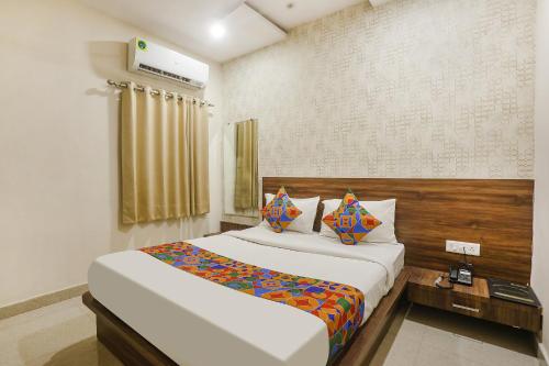 a bedroom with a large white bed in a room at FabHotel Prince Mama in Gwalior
