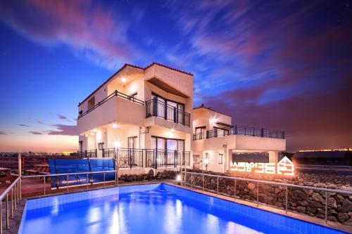 a house with a swimming pool in front of a building at Geumdanyoung Pension in Jeju