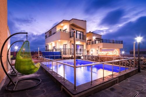 a house with a swimming pool in front of a house at Geumdanyoung Pension in Jeju